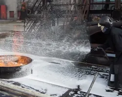 Traditional foam sprayed on burning ethanol fails to put out its nearly invisible flames; Dryfoam beads added to the pan form a raft that helps the foam suppress even polar solvents like ethanol